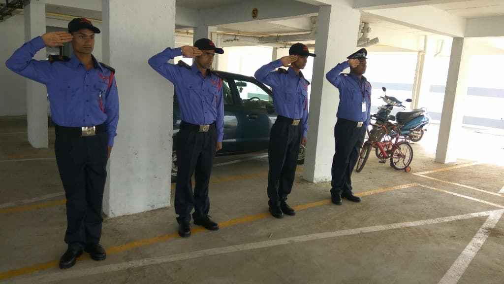 IVS Security guards saluting in a covered parking area